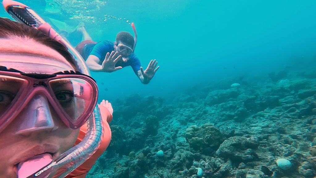a man and a woman snorkelling in Dharavandhoo