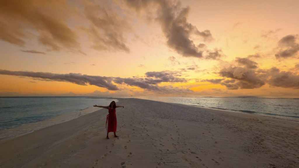 libby stands on the sand bar on fulhadhoo
