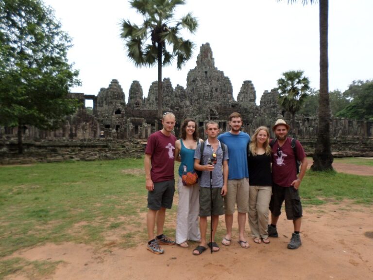 a group of friends outside angkor wat temple