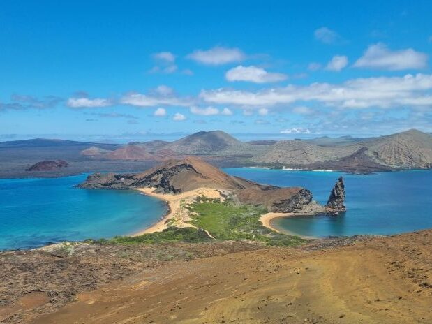 The famous viewpoint over Bartolome island in the Galapagos islands shows 2 half moon bays and bright blue ocean