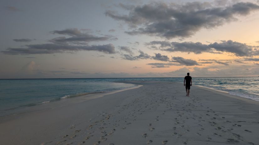 dave walks along the sandbar on fulhadhoo
